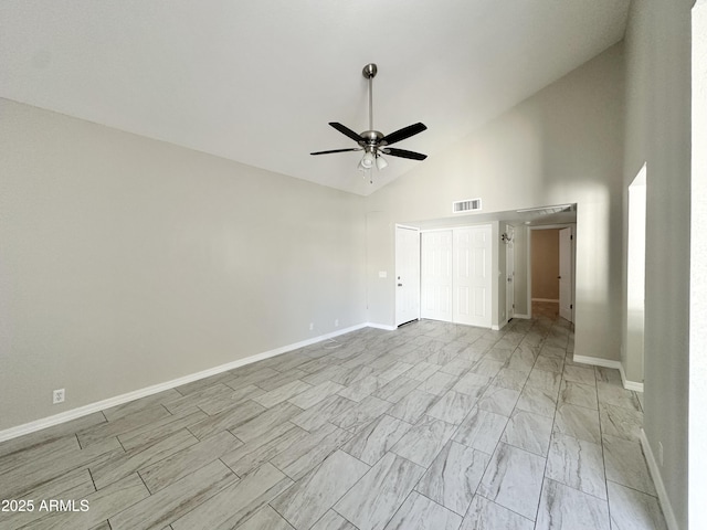 spare room featuring ceiling fan and high vaulted ceiling