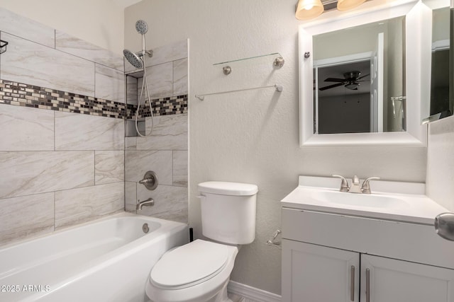 full bathroom featuring ceiling fan, tiled shower / bath, vanity, and toilet