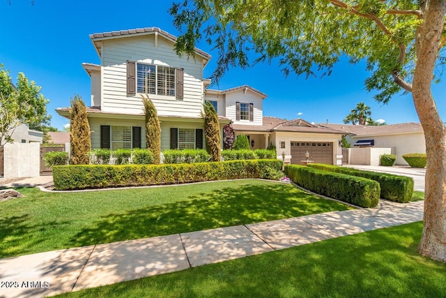 view of front of property featuring a garage and a front yard