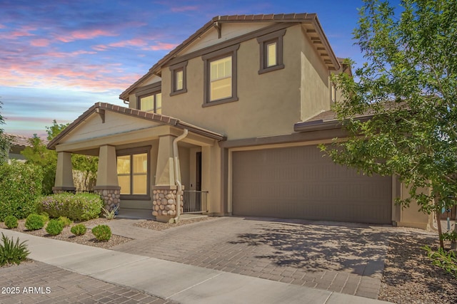 10221 E Wavelength Ave, Mesa, AZ 85212 - view of front facade with covered porch, a garage, decorative driveway, stucco siding, and a tiled roof