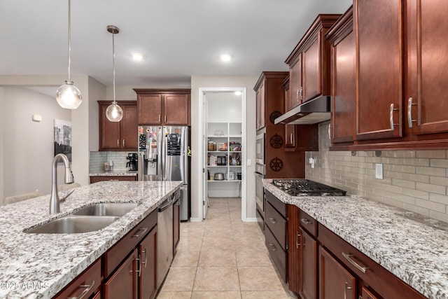 10221 E Wavelength Ave, Mesa, AZ 85212 - kitchen featuring stainless steel appliances, under cabinet range hood, decorative light fixtures, tasteful backsplash, and light tile patterned flooring
