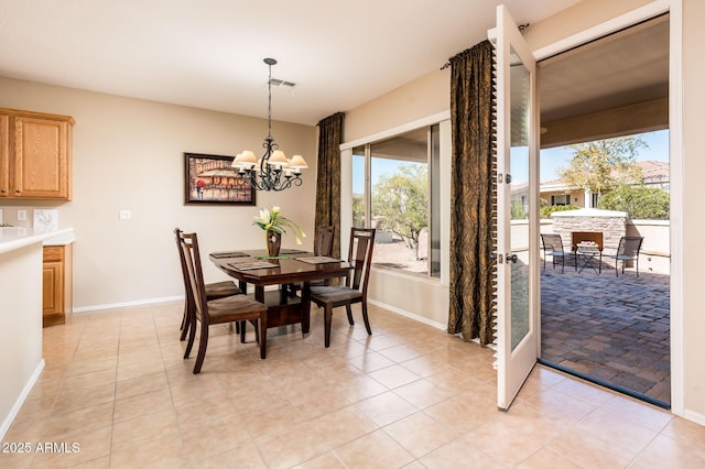 tiled dining room with a notable chandelier