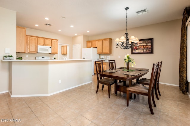 dining area featuring light tile patterned flooring and an inviting chandelier