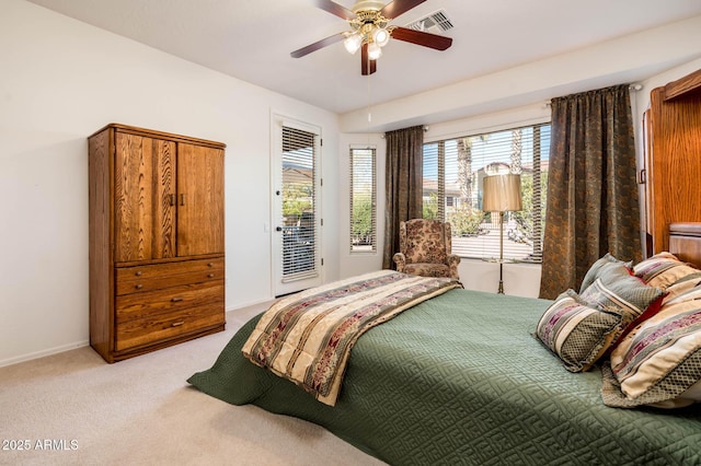 bedroom featuring access to exterior, light colored carpet, and ceiling fan