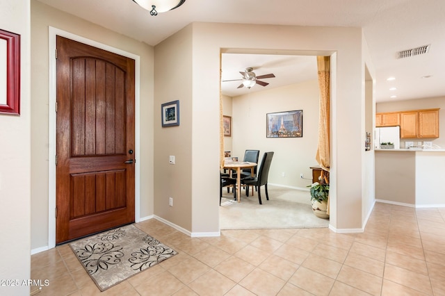 tiled entrance foyer featuring ceiling fan