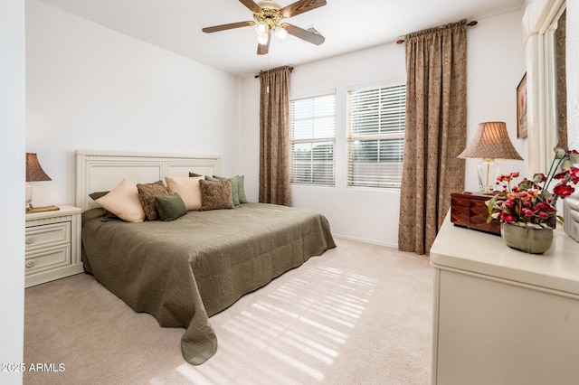 bedroom featuring light colored carpet and ceiling fan