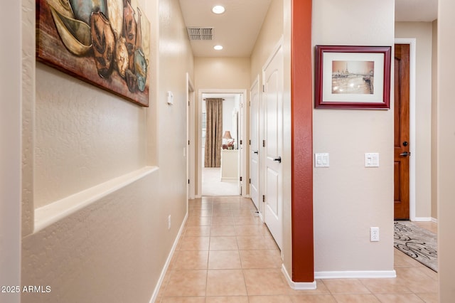 corridor featuring light tile patterned flooring