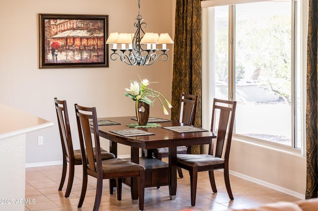 tiled dining area featuring an inviting chandelier