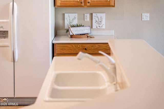 interior details with white refrigerator with ice dispenser and sink