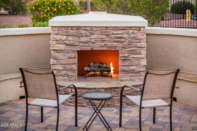 view of patio / terrace featuring an outdoor stone fireplace