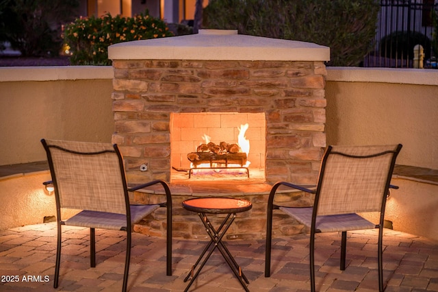 view of patio / terrace featuring an outdoor stone fireplace