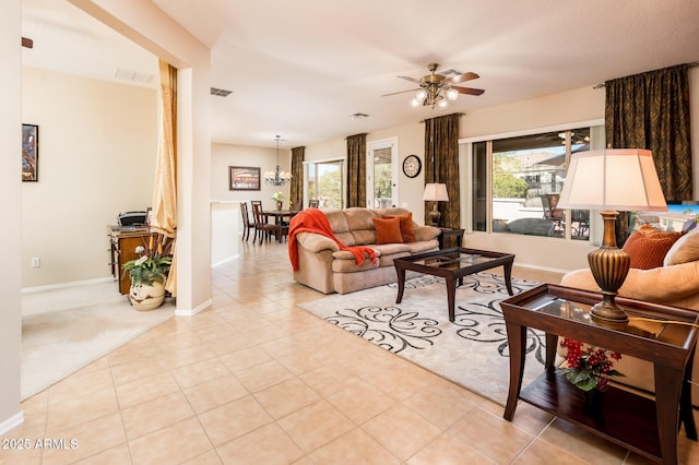 living room with light tile patterned flooring, plenty of natural light, and ceiling fan