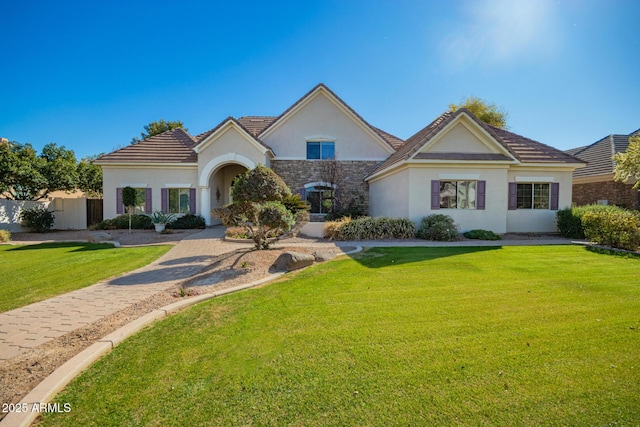 view of front of home featuring stone siding, a front lawn, and stucco siding