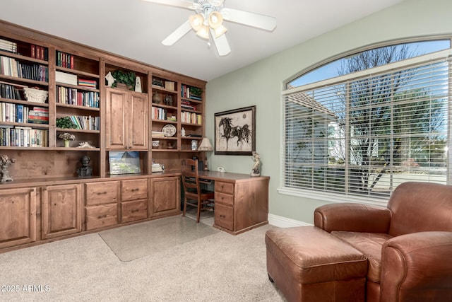 office area with baseboards and a ceiling fan