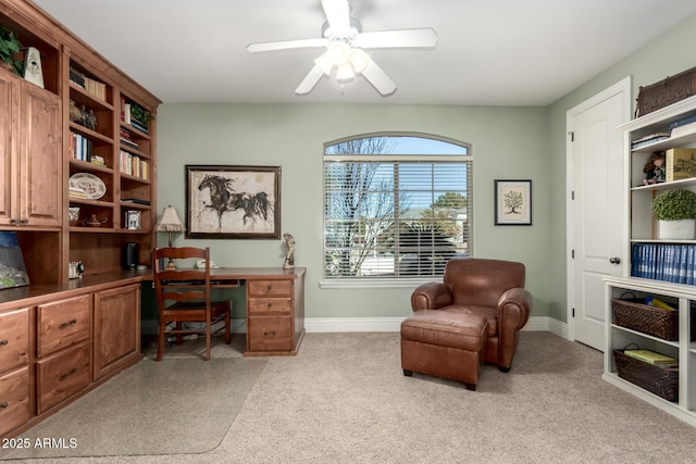 office with ceiling fan, light colored carpet, and baseboards