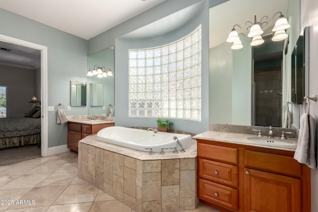 full bathroom with two vanities, ensuite bathroom, a sink, tile patterned flooring, and plenty of natural light