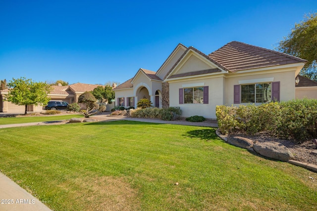 ranch-style home with a front yard and stucco siding