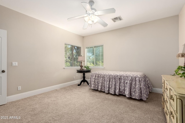 bedroom with baseboards, visible vents, and light colored carpet