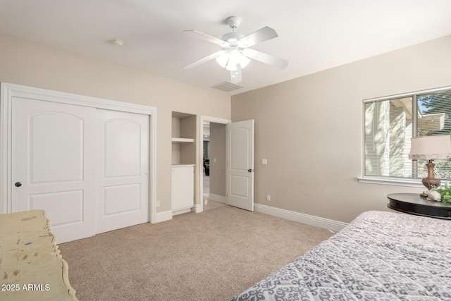 bedroom with ceiling fan, light carpet, visible vents, baseboards, and a closet