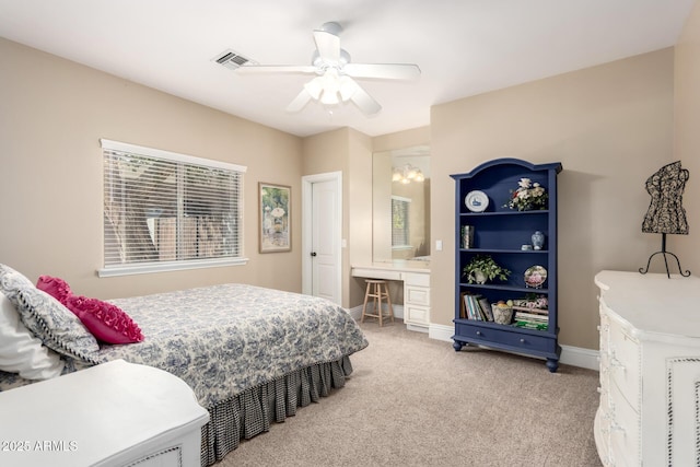 carpeted bedroom featuring visible vents, baseboards, and ceiling fan