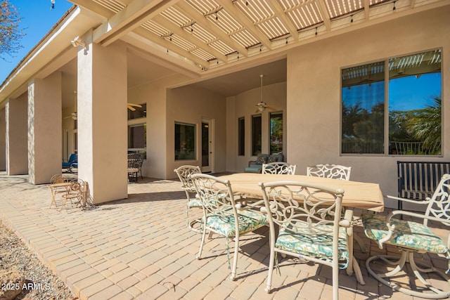 view of patio with a ceiling fan, outdoor dining space, and a pergola