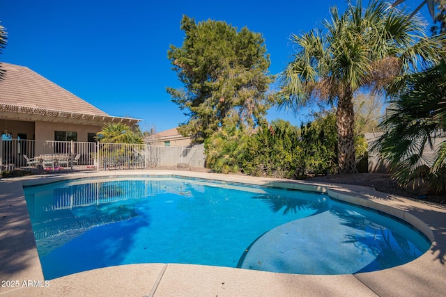 view of swimming pool with a fenced in pool and fence