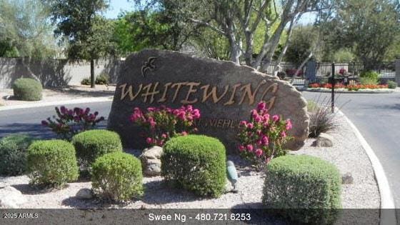 community sign featuring fence