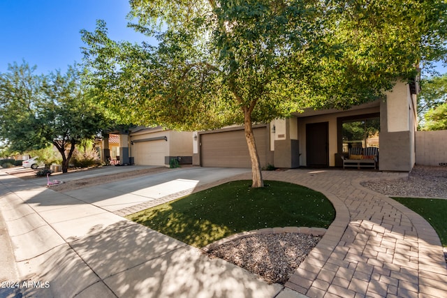 view of property hidden behind natural elements with a garage