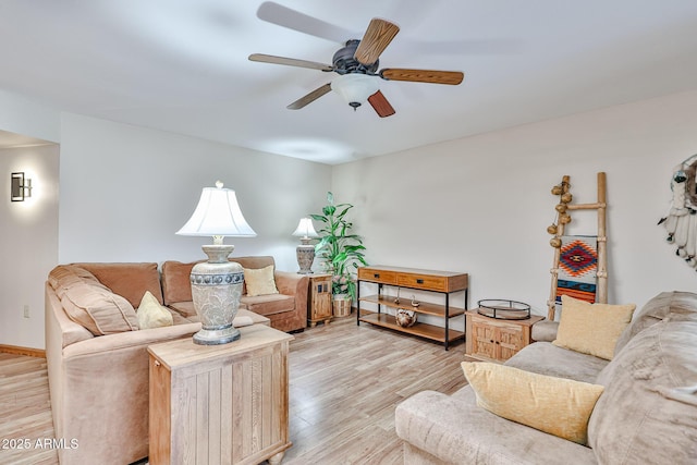 living room featuring ceiling fan and light hardwood / wood-style flooring