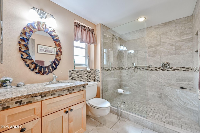 bathroom with vanity, toilet, a shower with shower door, and tile patterned floors