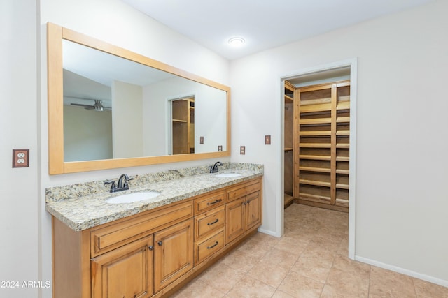 bathroom featuring tile patterned flooring, vanity, and ceiling fan