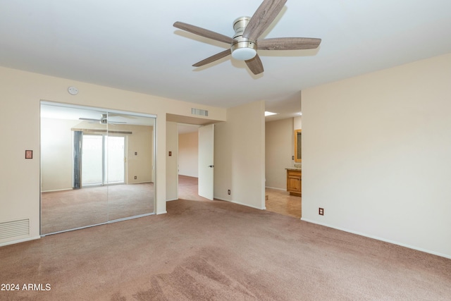 unfurnished room featuring light carpet and ceiling fan