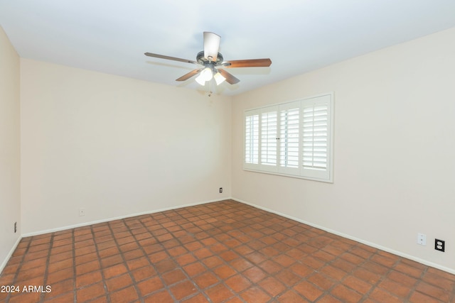 tiled empty room with ceiling fan