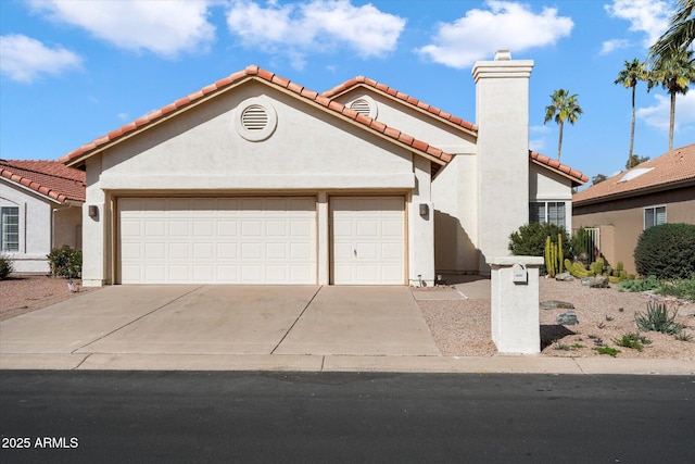 view of front of home featuring a garage, concrete driveway, a tile roof, a chimney, and stucco siding