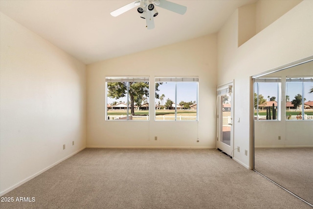 spare room featuring carpet floors, a wealth of natural light, and vaulted ceiling