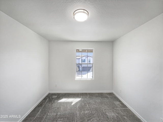 carpeted empty room with baseboards