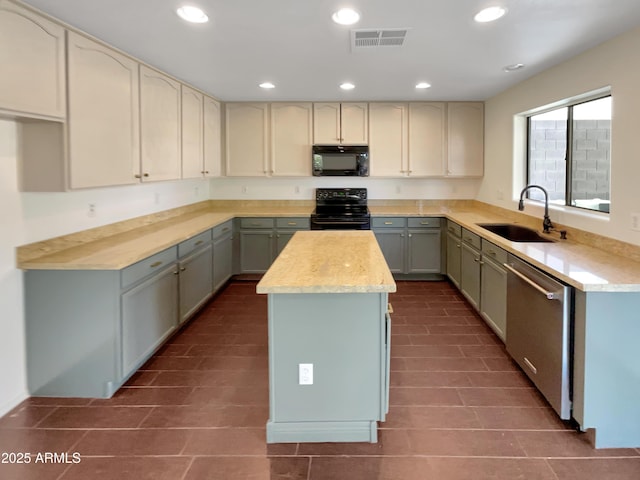 kitchen with sink, a center island, gray cabinetry, and black appliances