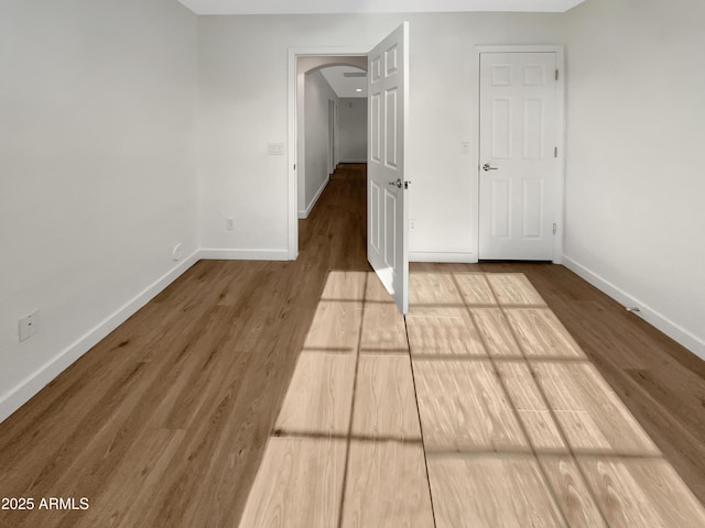 unfurnished bedroom with hardwood / wood-style flooring