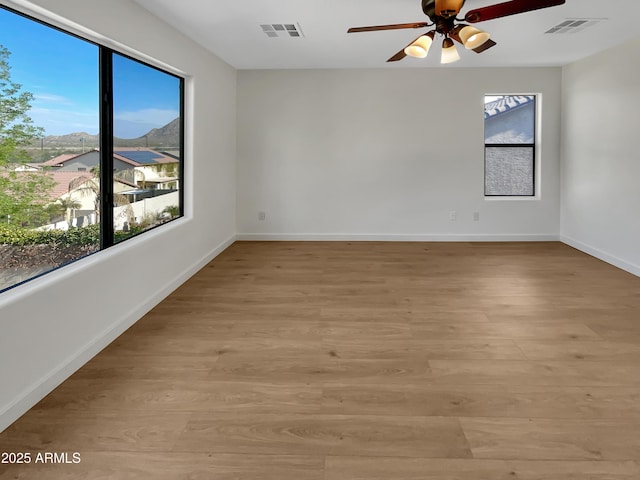 unfurnished room featuring light hardwood / wood-style floors and ceiling fan