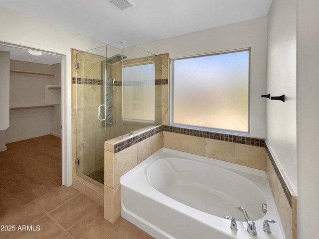 bathroom featuring separate shower and tub and tile patterned flooring