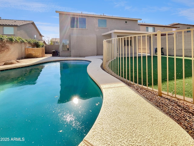 view of pool with a lawn