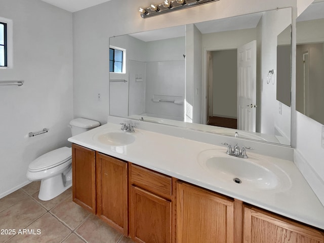 bathroom with tile patterned flooring, vanity, and toilet