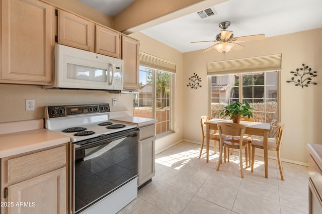 kitchen featuring visible vents, range with electric cooktop, light brown cabinetry, light countertops, and white microwave