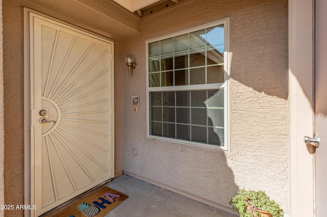 property entrance featuring stucco siding