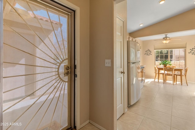 interior space featuring light tile patterned floors, recessed lighting, baseboards, and vaulted ceiling