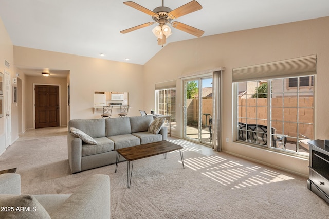 living room with a ceiling fan, carpet, and high vaulted ceiling