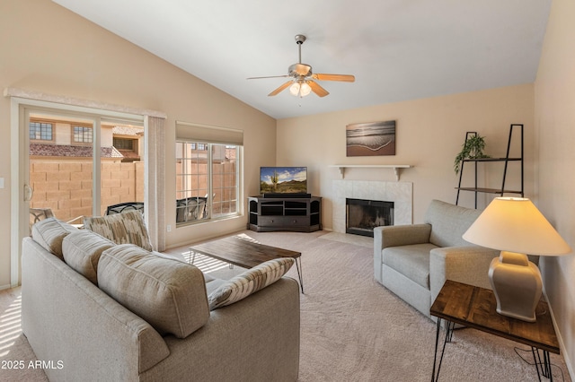 carpeted living room featuring lofted ceiling, ceiling fan, and a fireplace