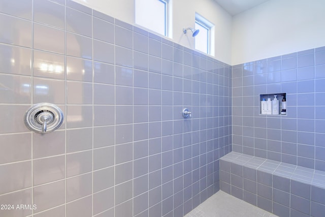 bathroom with tiled shower