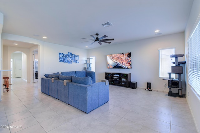 tiled living room featuring ceiling fan