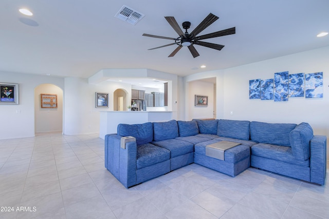 tiled living room featuring ceiling fan